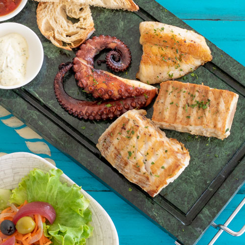 LobStar Enjoyable Seafood Restaurant | An Ocean of Cape Verdean flavors | tasting of three different griddle fish fillets and an octopus tentacle, with criola and LobStar sauces, served with balsamic salad